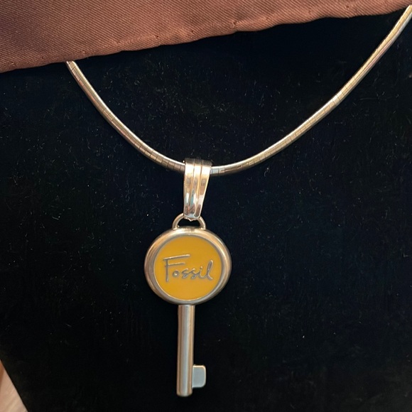 Velvet’s Designs Jewelry - Fossil emblem re-purposed Sz 3.25 long 2 inches wide.  Yellow accent in middle.